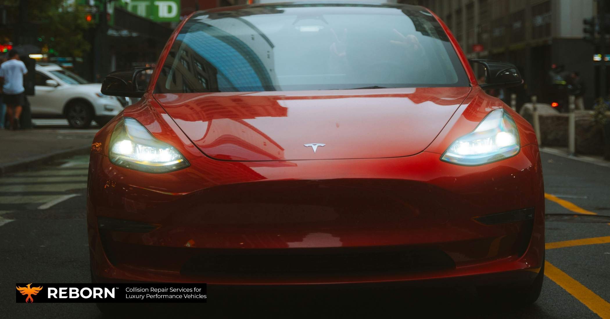 Mechanic inspecting a used Tesla Model 3